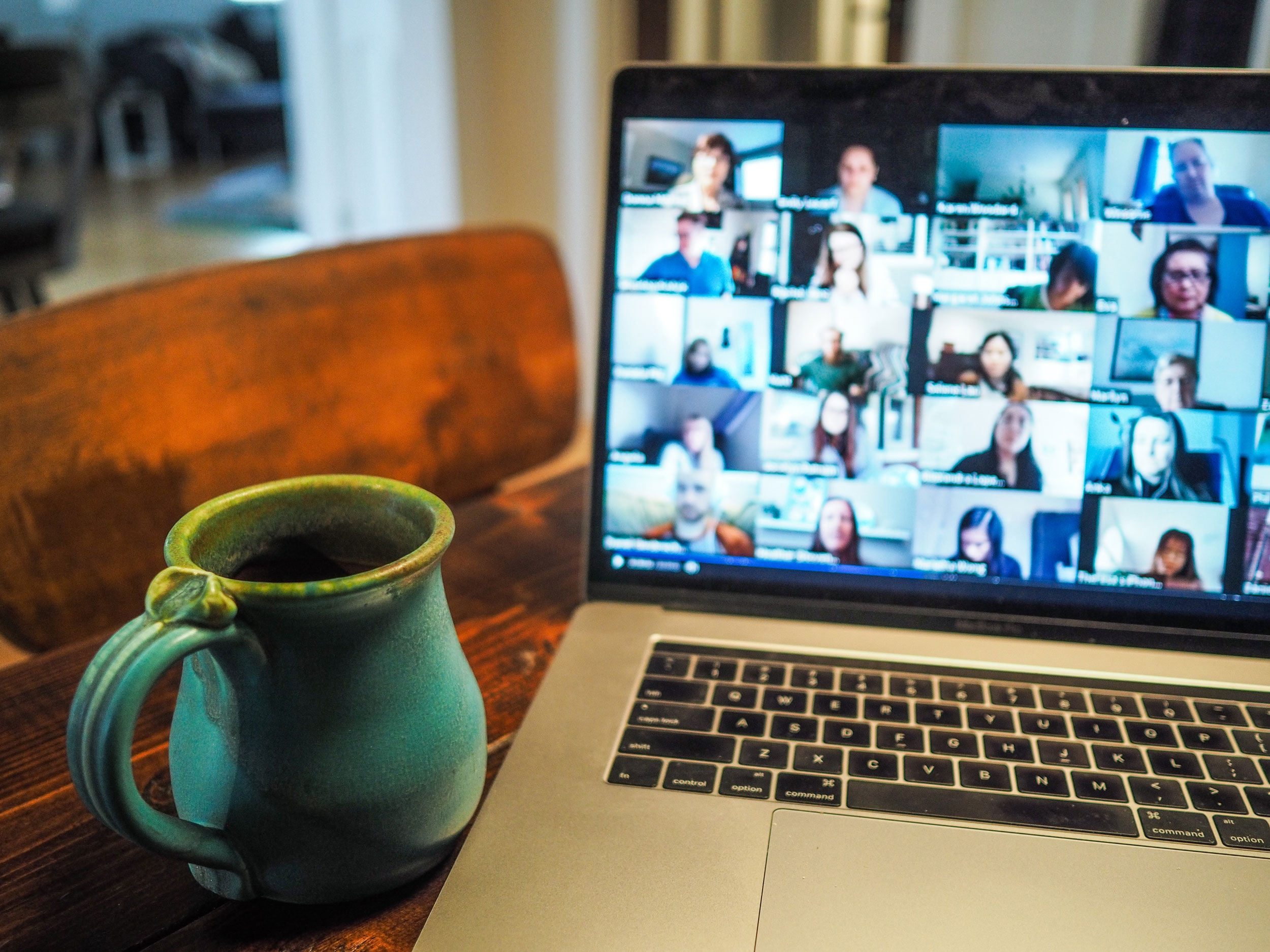 laptop displaying several people on a video call.